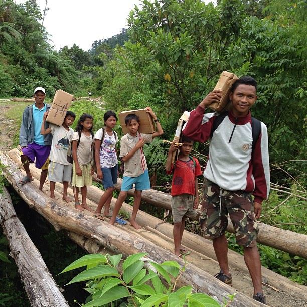 Mintosing teacher and students carrying their books